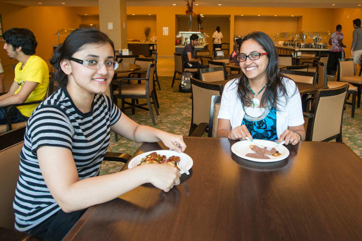 INTO Mason students enjoy a meal in the Globe, the Global Center cafeteria on the Fairfax Campus
